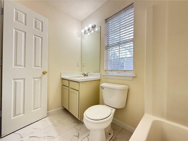 full bathroom with baseboards, a textured ceiling, marble finish floor, and vanity