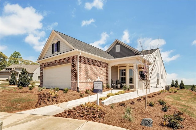 view of front of property featuring central AC, a porch, and a garage