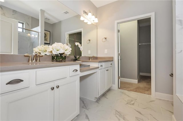 bathroom with vanity and a shower with door