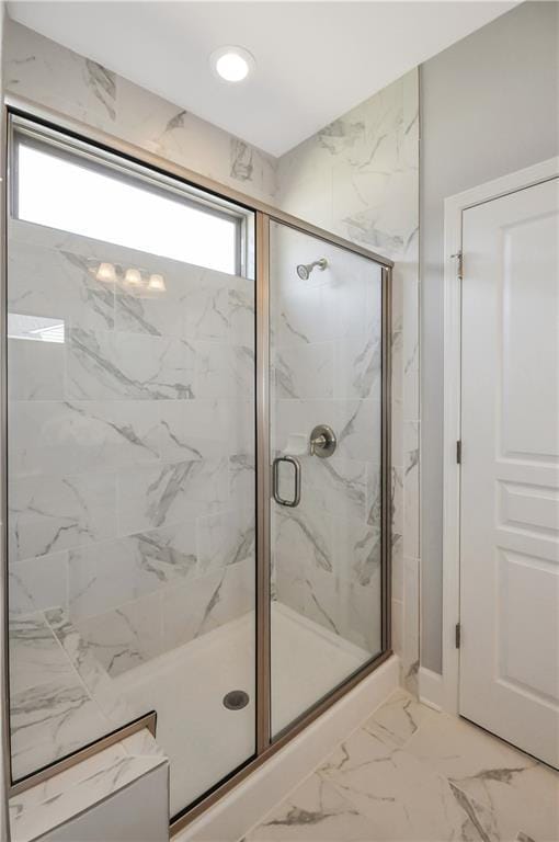 bathroom with a shower with door