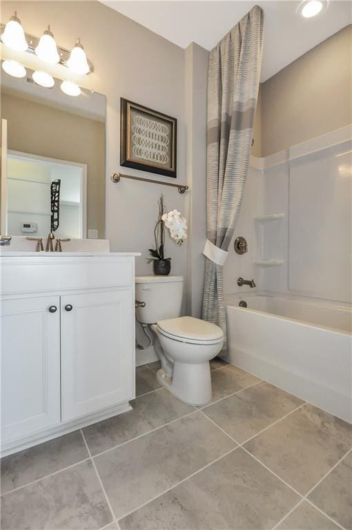 full bathroom featuring toilet, shower / bath combo, vanity, and tile patterned floors