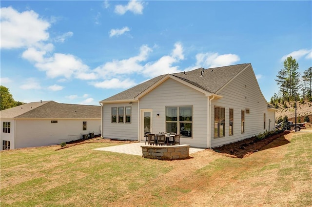 back of house featuring a patio area and a yard