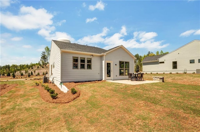 rear view of property with a yard, a patio area, and central air condition unit