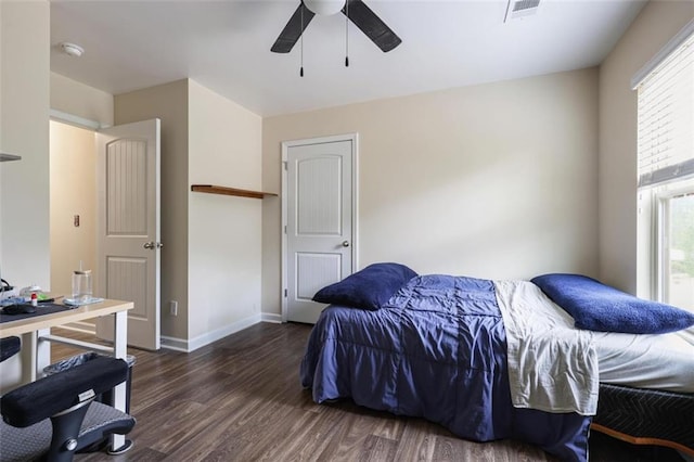 bedroom with ceiling fan, wood finished floors, visible vents, and baseboards