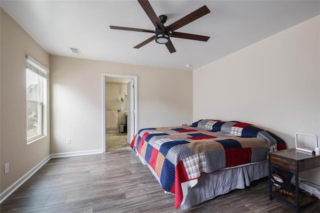 bedroom featuring visible vents, ceiling fan, baseboards, and wood finished floors