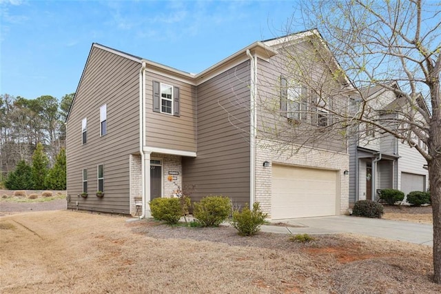 view of front of house featuring brick siding, an attached garage, and concrete driveway