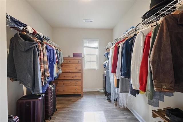 walk in closet with wood finished floors and visible vents