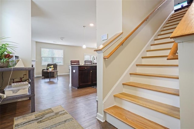 stairs with baseboards and wood finished floors