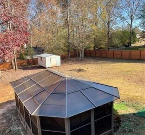 view of pool featuring a storage shed, an outdoor structure, and fence