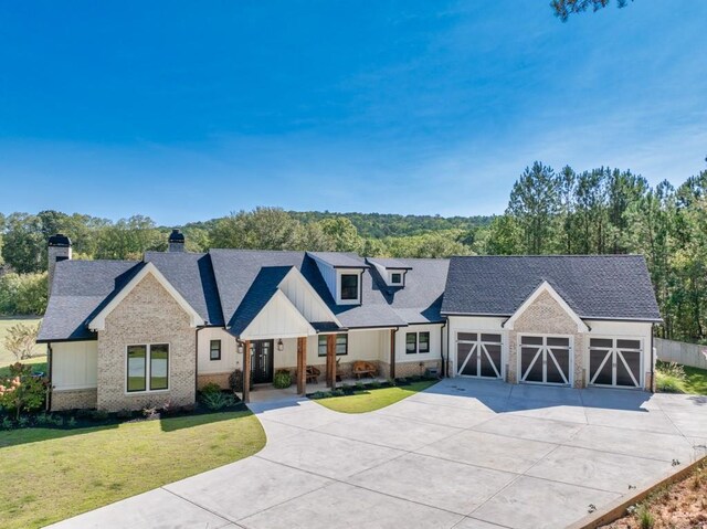 modern farmhouse with a garage and a front yard