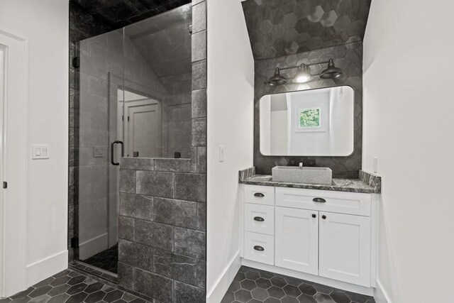 bathroom with vanity and a shower with door