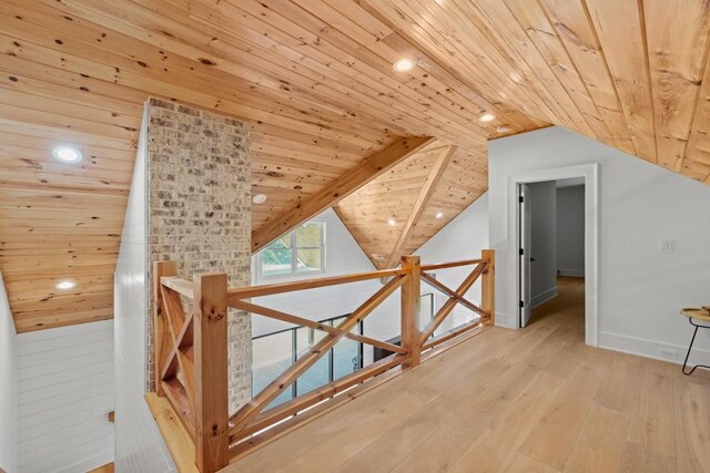 additional living space with lofted ceiling, light hardwood / wood-style flooring, and wooden ceiling