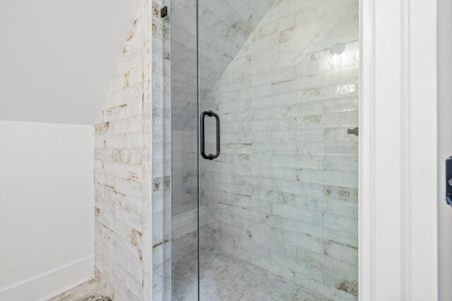 bathroom with lofted ceiling and walk in shower