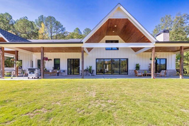 back of house featuring a yard and a patio