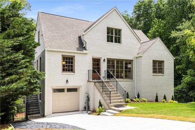 1327 Harvard Rd NE, Atlanta, GA 30306 - view of front facade featuring brick siding, a garage, concrete driveway, and a shingled roof