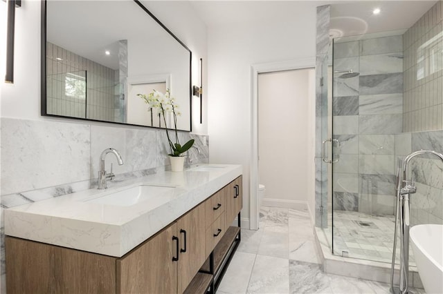 1327 Harvard Rd NE, Atlanta, GA 30306 - bathroom featuring a shower stall, a freestanding tub, marble finish flooring, double vanity, and toilet