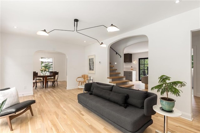 1327 Harvard Rd NE, Atlanta, GA 30306 - living area with arched walkways, light wood-style floors, stairs, recessed lighting, and baseboards