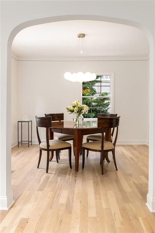 1327 Harvard Rd NE, Atlanta, GA 30306 - dining room with arched walkways, light wood-style flooring, and baseboards