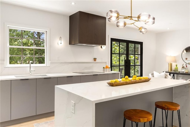 1327 Harvard Rd NE, Atlanta, GA 30306 - kitchen with a sink, modern cabinets, gray cabinetry, a kitchen breakfast bar, and recessed lighting
