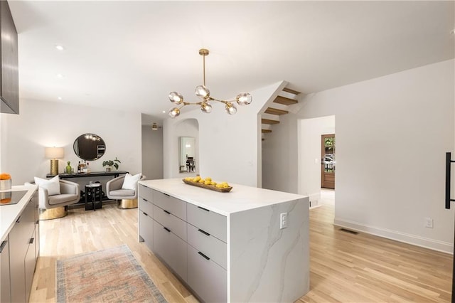 1327 Harvard Rd NE, Atlanta, GA 30306 - kitchen featuring modern cabinets, arched walkways, a center island, light countertops, and light wood-type flooring