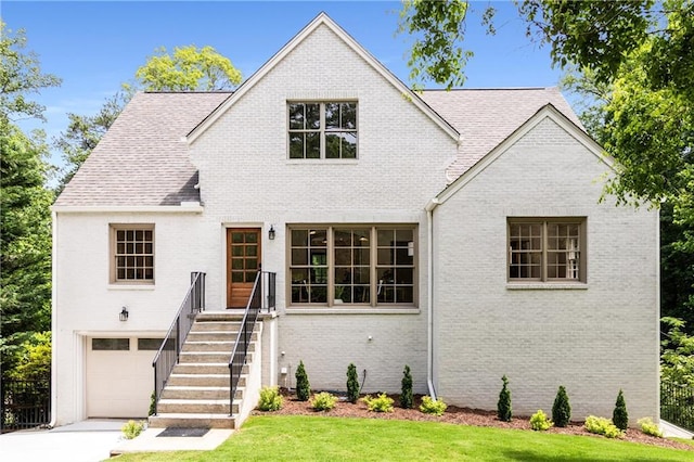 1327 Harvard Rd NE, Atlanta, GA 30306 - view of front of property featuring brick siding, a garage, and driveway