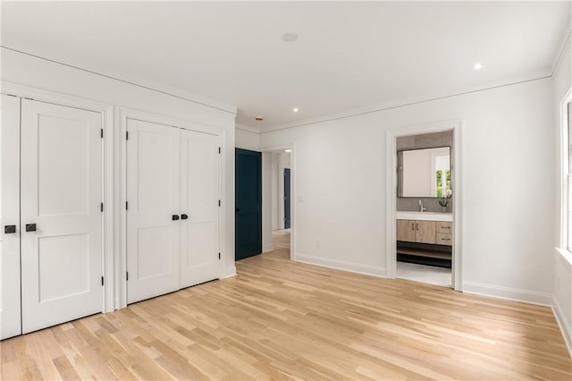 1327 Harvard Rd NE, Atlanta, GA 30306 - unfurnished bedroom featuring two closets, light wood-style floors, connected bathroom, baseboards, and recessed lighting