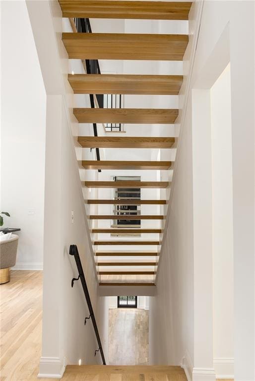 1327 Harvard Rd NE, Atlanta, GA 30306 - staircase with baseboards and wood finished floors