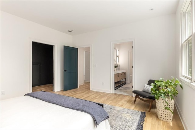 1327 Harvard Rd NE, Atlanta, GA 30306 - bedroom with light wood-type flooring, baseboards, and ensuite bathroom