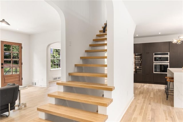 1327 Harvard Rd NE, Atlanta, GA 30306 - stairway with arched walkways, wood finished floors, recessed lighting, and baseboards