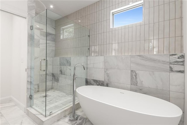 1327 Harvard Rd NE, Atlanta, GA 30306 - bathroom with marble finish floors, tile walls, a freestanding tub, a stall shower, and baseboards