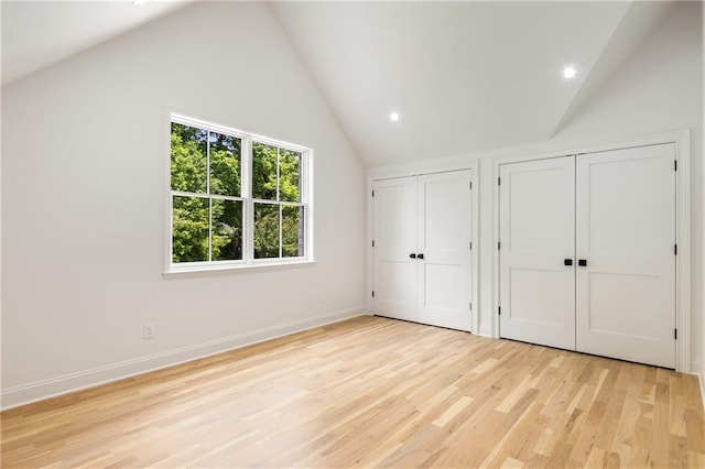 1327 Harvard Rd NE, Atlanta, GA 30306 - unfurnished bedroom with lofted ceiling, two closets, light wood-style flooring, baseboards, and recessed lighting