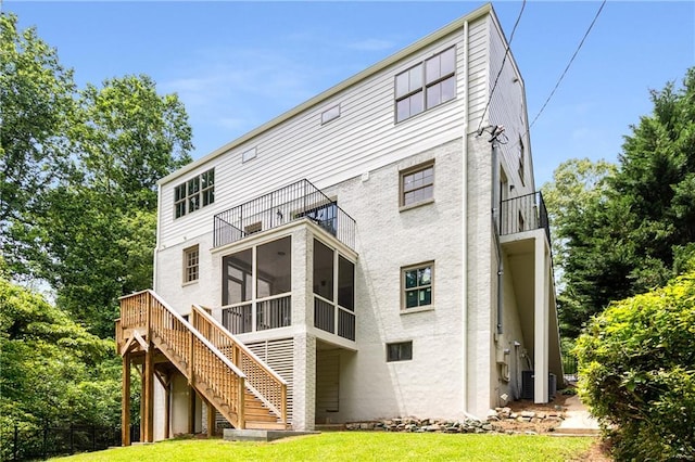 1327 Harvard Rd NE, Atlanta, GA 30306 - back of property featuring a balcony, a sunroom, stairs, a lawn, and stucco siding