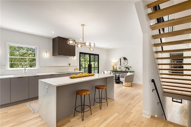 1327 Harvard Rd NE, Atlanta, GA 30306 - kitchen with a sink, modern cabinets, light countertops, a kitchen bar, and recessed lighting