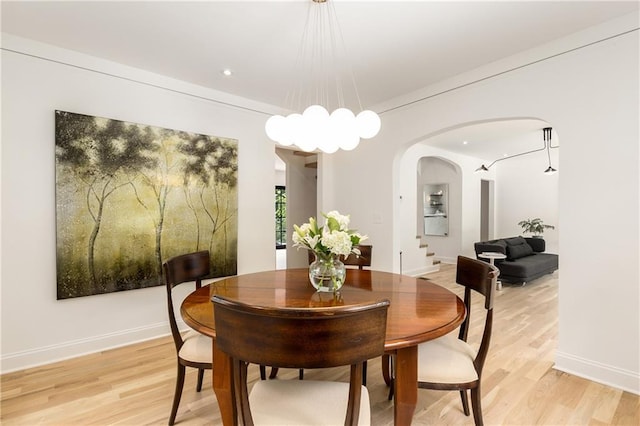 1327 Harvard Rd NE, Atlanta, GA 30306 - dining space with arched walkways, light wood finished floors, recessed lighting, and a chandelier