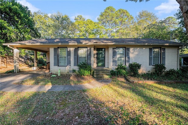 ranch-style home featuring a carport and a front yard