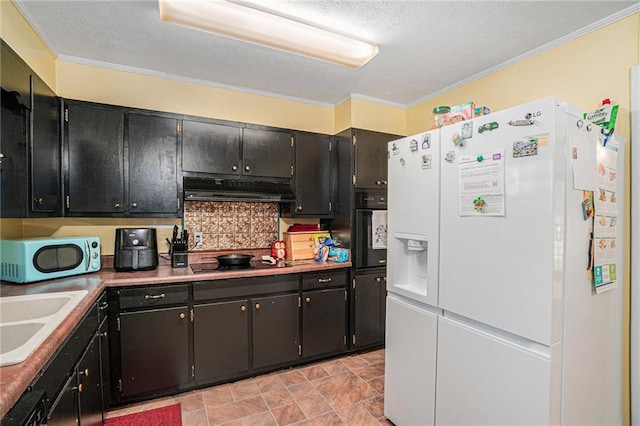 kitchen featuring crown molding, tasteful backsplash, black appliances, and sink