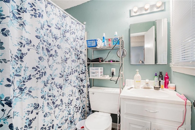 bathroom with vanity, toilet, and walk in shower