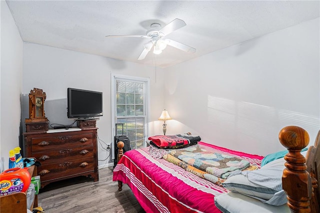 bedroom with light hardwood / wood-style floors and ceiling fan