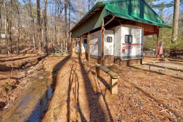 view of property exterior featuring metal roof