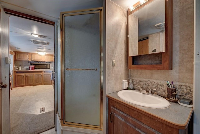 full bathroom featuring a shower stall and vanity