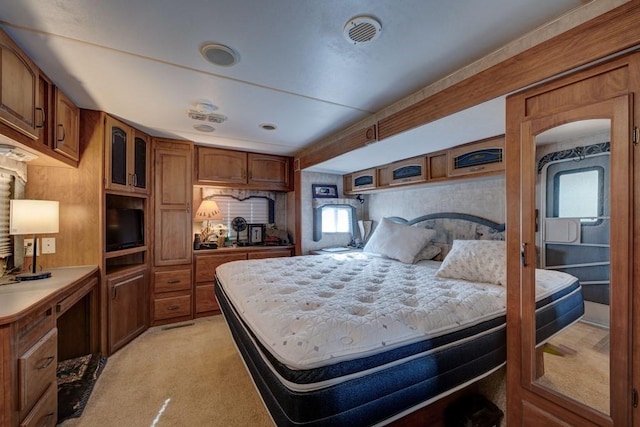 bedroom featuring light colored carpet