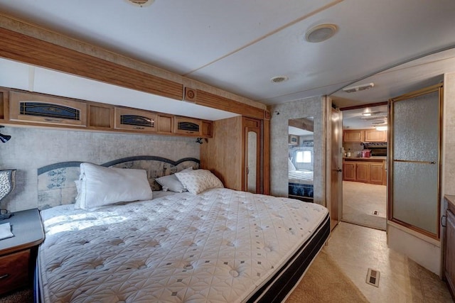 bedroom featuring light carpet and visible vents