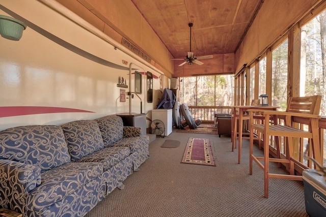 sunroom with wooden ceiling and ceiling fan