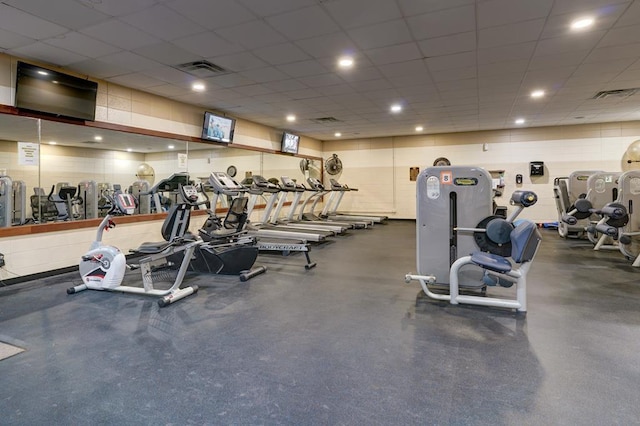 workout area with a paneled ceiling and visible vents