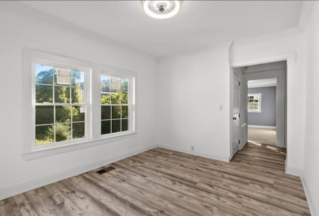 unfurnished room with wood-type flooring