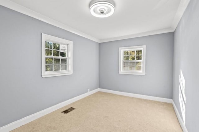 carpeted empty room with ornamental molding