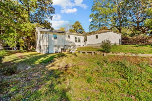 rear view of property with a lawn