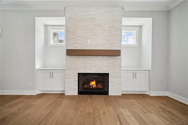 591 Brashy St, Woodstock, GA 30188 - unfurnished living room featuring a stone fireplace, wood finished floors, and baseboards
