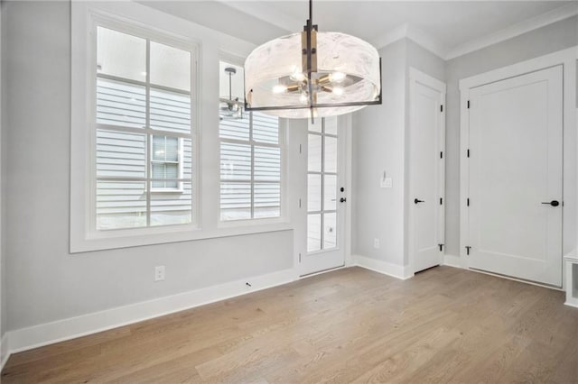 591 Brashy St, Woodstock, GA 30188 - unfurnished dining area featuring a chandelier, wood finished floors, baseboards, and ornamental molding
