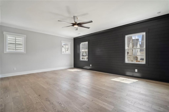591 Brashy St, Woodstock, GA 30188 - unfurnished room featuring healthy amount of natural light, baseboards, light wood-type flooring, and wood walls